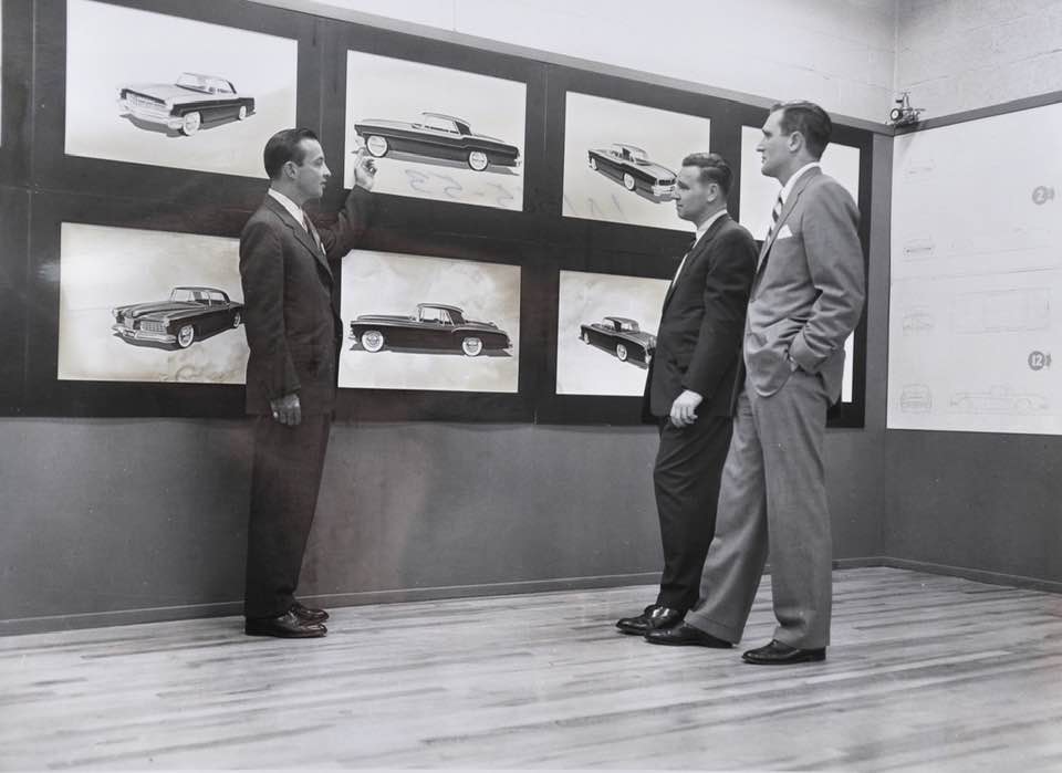 bw photo guys looking at wall renderings n