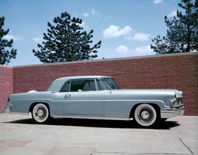 posed vehicle by brickwall