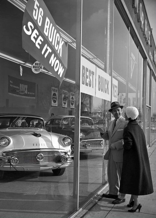 56 buick staring through dealership window