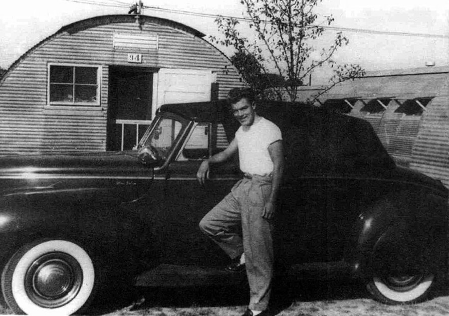 A young Dave Holls standing next to an early Ford model Deans Garage RESIZED 1