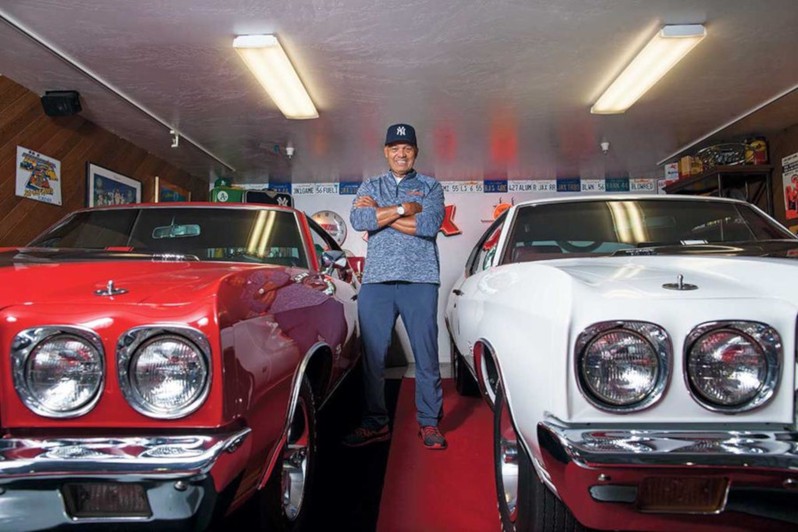 Reggie Jackson stands between two Chevy Chevelles RESIZED