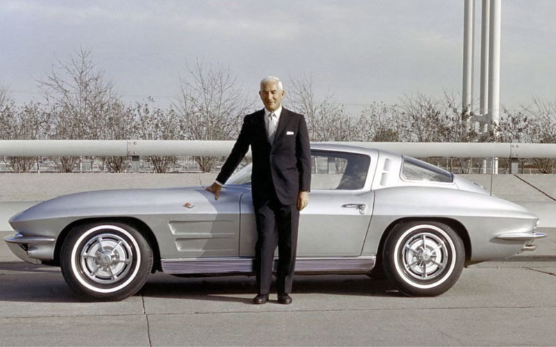 Zora Arkus Duntov standing with a 1960s Corvette 4