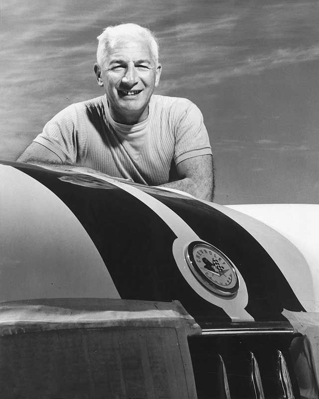 Zora Arkus Duntov standing with a Corvette model 2